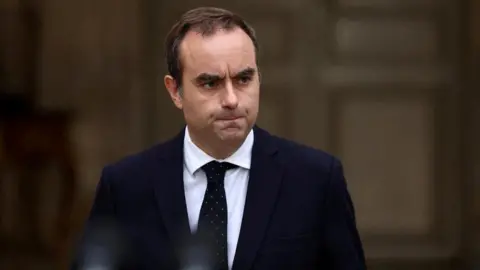 French Prime Minister Secures Critical Budget Vote Amid Pressure