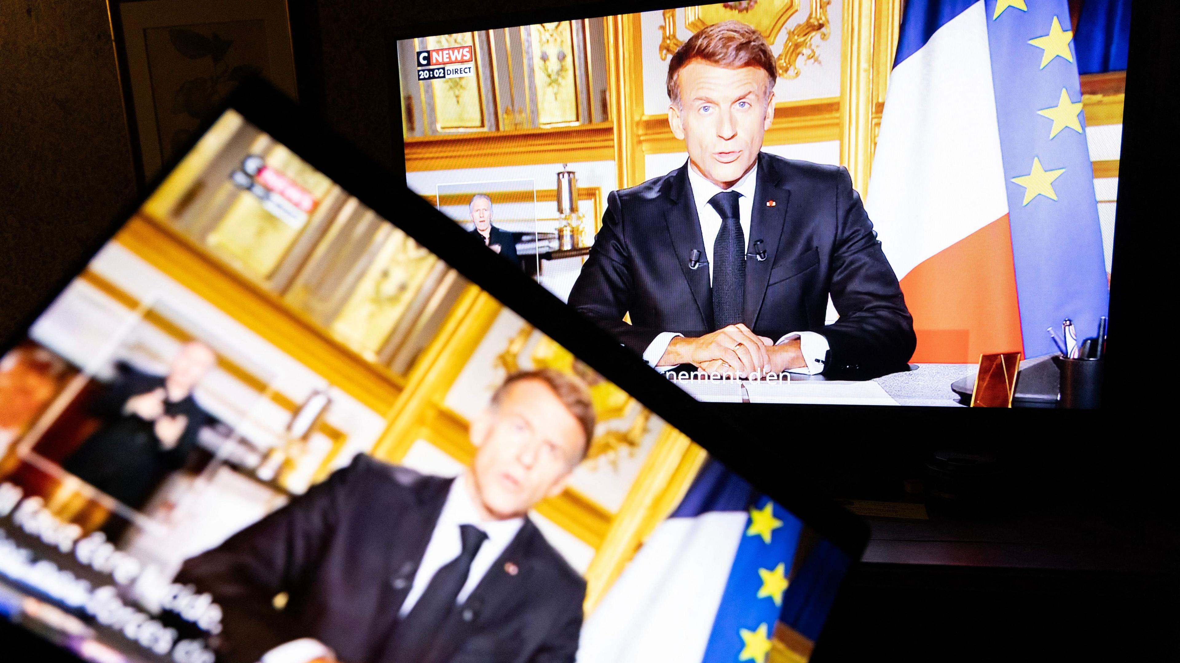 Address by the President of the French Republic Emmanuel Macron on a television screen and a laptop in a home the day after the violence committed at the national demonstration