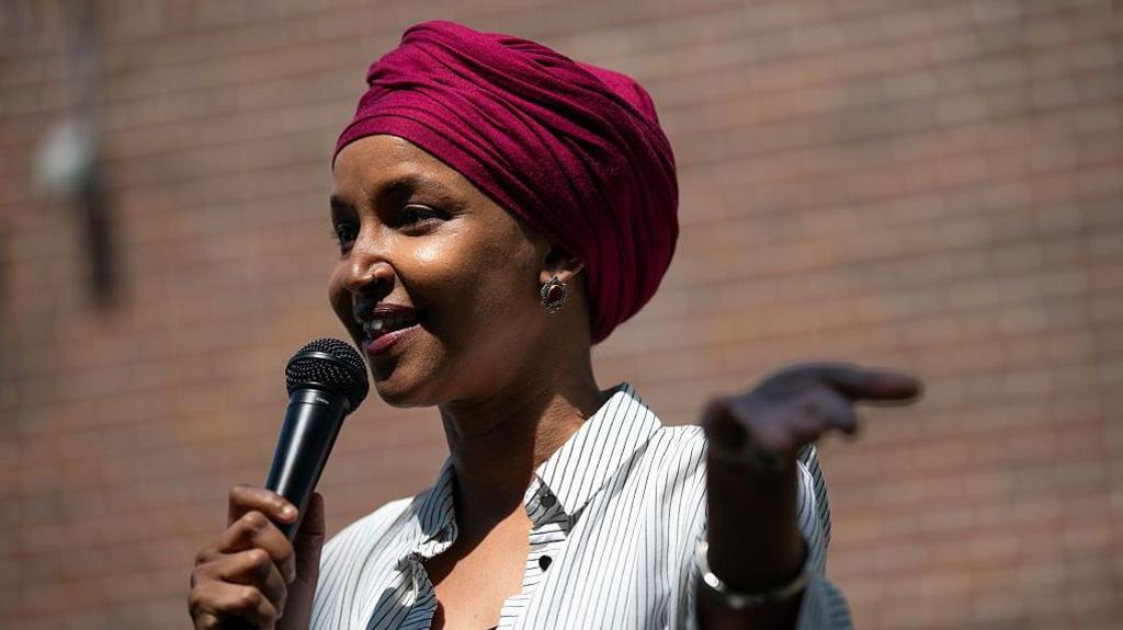Ilhan Omar speaking at a podium